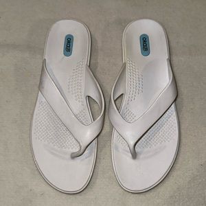 Lightly worn white flip flops